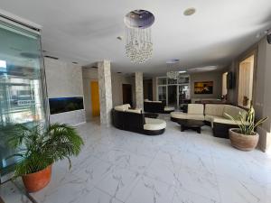 a large living room with couches and a chandelier at SunBorn Hotel in Golem