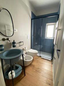 a bathroom with a toilet and a sink and a shower at Nonno Nicola Rooms in Bari