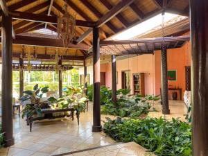 a patio with a bunch of plants in a building at Mangos 13 Beautiful 5 bedroom villa with maid golf cart in La Romana