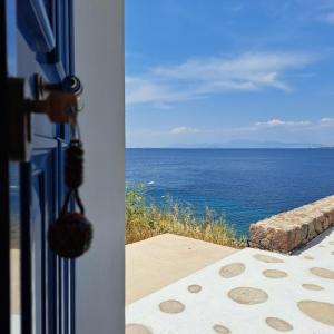 a view of the ocean from a house door at Ithaca in Perdika
