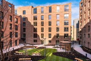 a group of brick buildings with a courtyard at Hudson Quarter Luxury Apartments in York