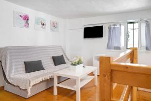 een witte woonkamer met een bank en een tafel bij Arrecife 4 U in Arrecife