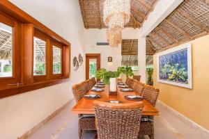 a dining room with a long table and chairs at YARARI 17 PRIVATE RETREAT W POOL JACUZZI MAiD in Punta Cana