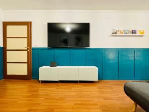 a living room with blue cabinets and a white table at Garibaldi Accommodation in Viterbo