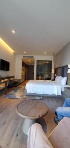 a large hotel room with a bed and a table at Apec Mandala Wyndham mui ne 1912A in Ấp Thiẹn Ái