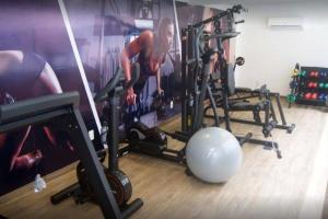 a room with a gym with a man working out at Nomar VI - Gold Flat in João Pessoa