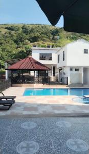 a house with a swimming pool and a building at Naru in Utica