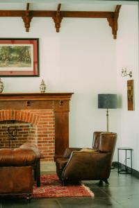 a living room with a chair and a fireplace at Kili Seasons Hotel in Arusha