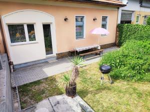 a patio with a bench and an umbrella and a grill at Apartment Sunside in Mýto