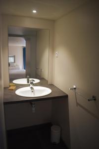 a bathroom with a sink and a mirror at La Cour de l'Olivier in Lussas