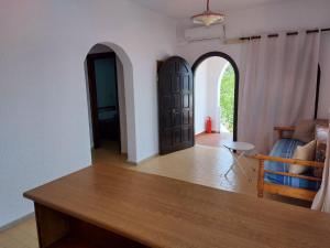 a living room with a table and two arched doors at Anthy Villas department 1 in Mardhátion