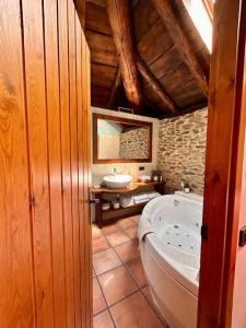 a bathroom with a large tub and a sink at Cobert de Felip 