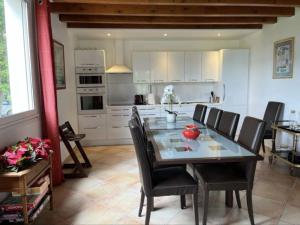 a kitchen and dining room with a table and chairs at Ferme Binel à Ronsac in Aigrefeuille
