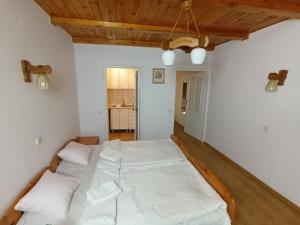 ein Schlafzimmer mit einem großen weißen Bett mit zwei Kissen in der Unterkunft Lipowy Przylądek- Domek 26 