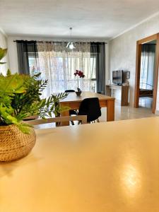 a living room with a table and a dining room table at Vittory house in Lido di Ostia