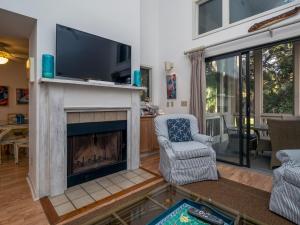a living room with a fireplace and a tv at 2780 Live Oak Villa in Seabrook Island
