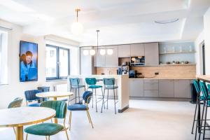 a kitchen and dining room with tables and chairs at The Base Berlin ONE in Berlin