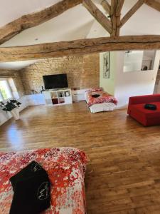 a room with three beds and a flat screen tv at Maison Laurenza La grande suite 1760 in Saint-Jean-de-Liversay +16 photos
