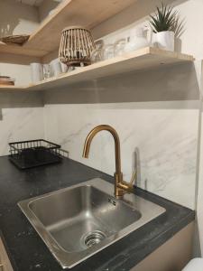 a kitchen sink with a black counter top at Casa Maria Flora in Ojén