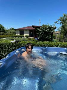 a young boy is in a swimming pool at Къща за гости, Guesthouse GOTINOTO in Krapets
