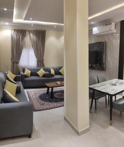 a living room with a couch and a table at Marka resort ماركاريزورت in Abha