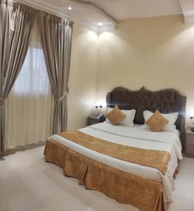 um quarto com uma cama grande e uma janela em Marka resort ماركاريزورت em Abha