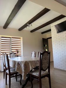 a dining room with a table with chairs and a tableablish at Nice House in Slavske