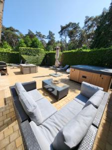 a patio with a couch and a table at villa 2be in Balen