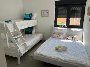 a bedroom with two bunk beds and a window at Apartman Mara Vodice in Vodice