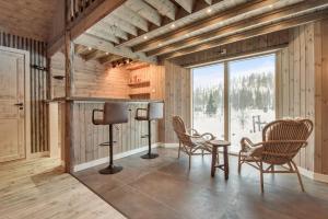 a room with chairs and a table and a window at Granheim in Namsskogan