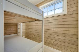 a sauna with wooden walls and a window at Granheim in Namsskogan