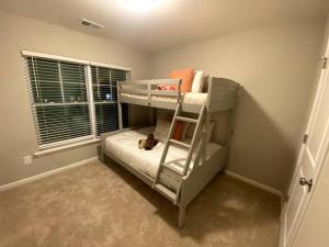 a bunk bed with a teddy bear on the bottom bunk at Brand NEW HOME mins to airport in Atlanta