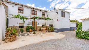 a white house with a courtyard in front of it at Cortijo Bustamante Baza by Ruralidays in Baza