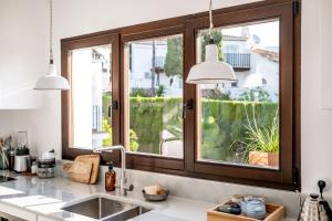a kitchen with two pendant lights above a sink at Golden Mile Designer Penthouse in Marbella