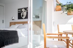 a bedroom with a bed and a table and a chair at Golden Mile Designer Penthouse in Marbella +30 photos