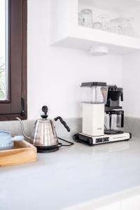 a kitchen counter with a coffee maker and a blender at Golden Mile Designer Penthouse in Marbella
