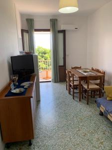 a living room with a table and a dining room at MARE CELESTE APPARTAMENTO in Sciacca