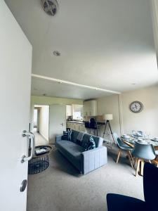 a living room with a couch and a table at Koala & Tree - Cozy and Centric 1 bed apartment - Short Lets & Serviced Accommodation Cambridge in Cambridge