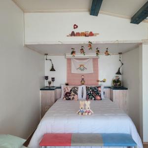 a bedroom with a large bed with pillows at Soulmate Pension in Namhae