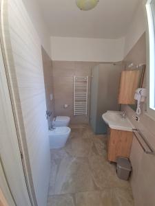 łazienka z 2 umywalkami i toaletą w obiekcie Casa Vacanza Fontana w mieście Manduria