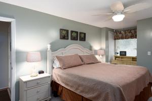 a bedroom with a bed and a ceiling fan at 1317 Pelican Watch Villa in Seabrook Island