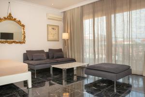 a living room with a couch and a table at City Chic Apartments in Limenas