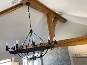 a chandelier hanging from a ceiling in a room at Luxury Self Catering Studio with vaulted ceiling in Ockley