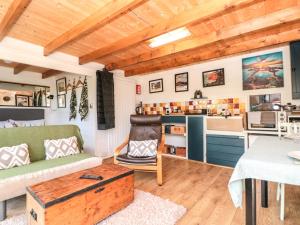 a living room with a couch and a table at Dart View Hideout in Totnes