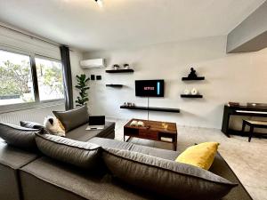 a living room with a couch and a tv at Mylos Ηome in Ierapetra