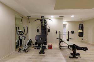 a gym with treadmills and exercise equipment in a room at Villa Mario Resort in Salò