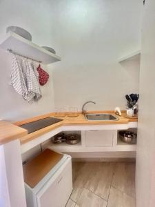 a kitchen with a sink and a counter top at A Casa dei Bruno B&B in Pozzuoli
