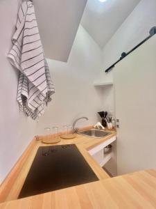 a kitchen with a sink and a counter with glasses at A Casa dei Bruno B&B in Pozzuoli
