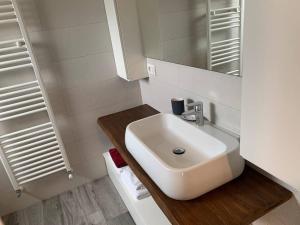 a white bathroom with a sink and a mirror at Colico City Life in Colico