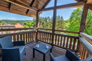 a view from the balcony of a cabin with chairs and a table at Rezydencja Klonowa in Ober Wüstegiersdorf